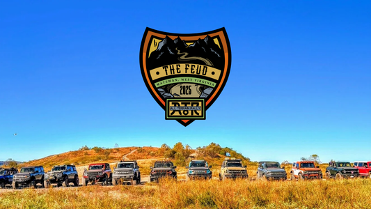 The Feud 2025 All-Terrain Rally badge above a lineup of Ford Broncos on a West Virginia trail in Matewan