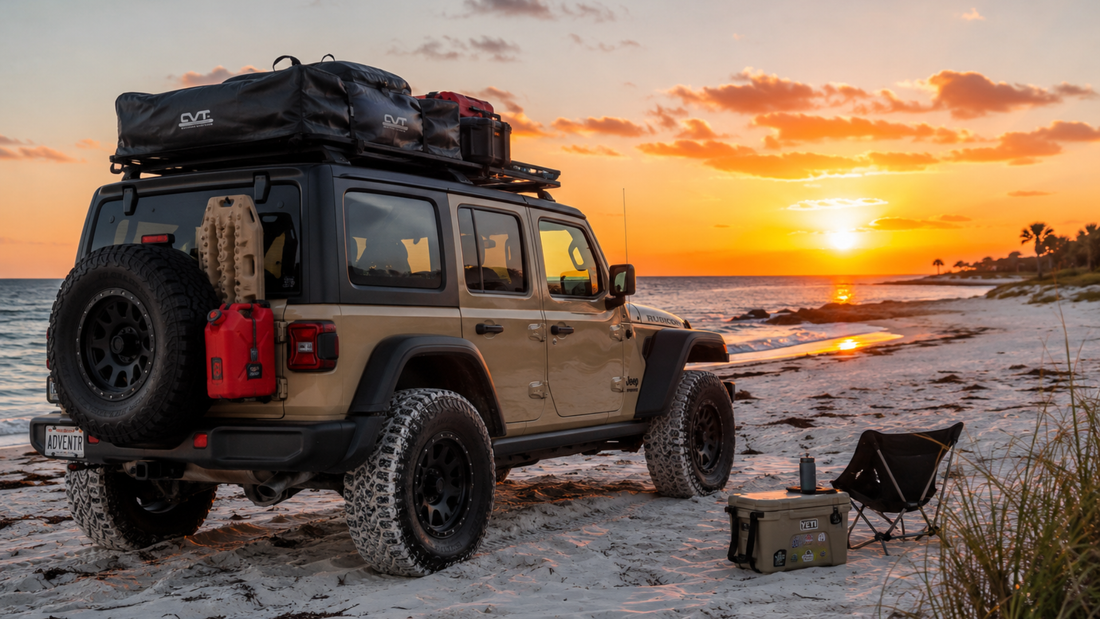 Jeep Wrangler JLU Rubicon with rooftop tent and overland gear parked on white sand beach at sunset