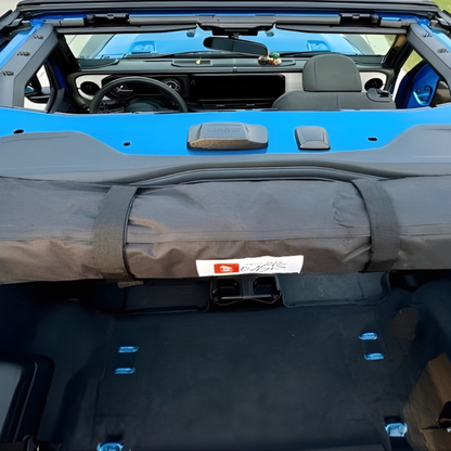 2-in-1 trail cover packed and stored inside 2-door Jeep Wrangler