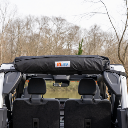 Trail Gear Oasis 2-in-1 Trail Cover & Sun Shade stored in roll bag on Bronco roll bar.