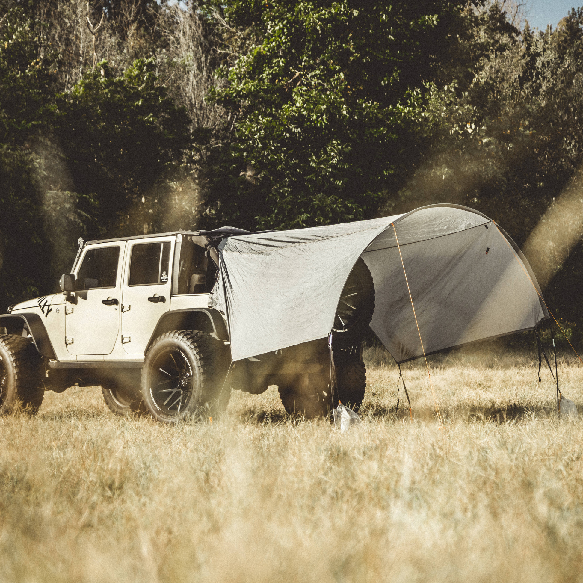 Trail Gear Oasis Jeep Trail Cover extended as sun shade canopy attached to Jeep Wrangler